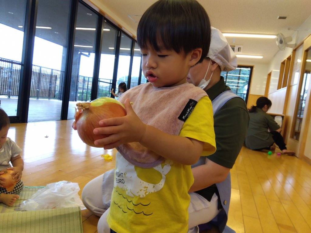 玉ねぎの皮をむく子ども