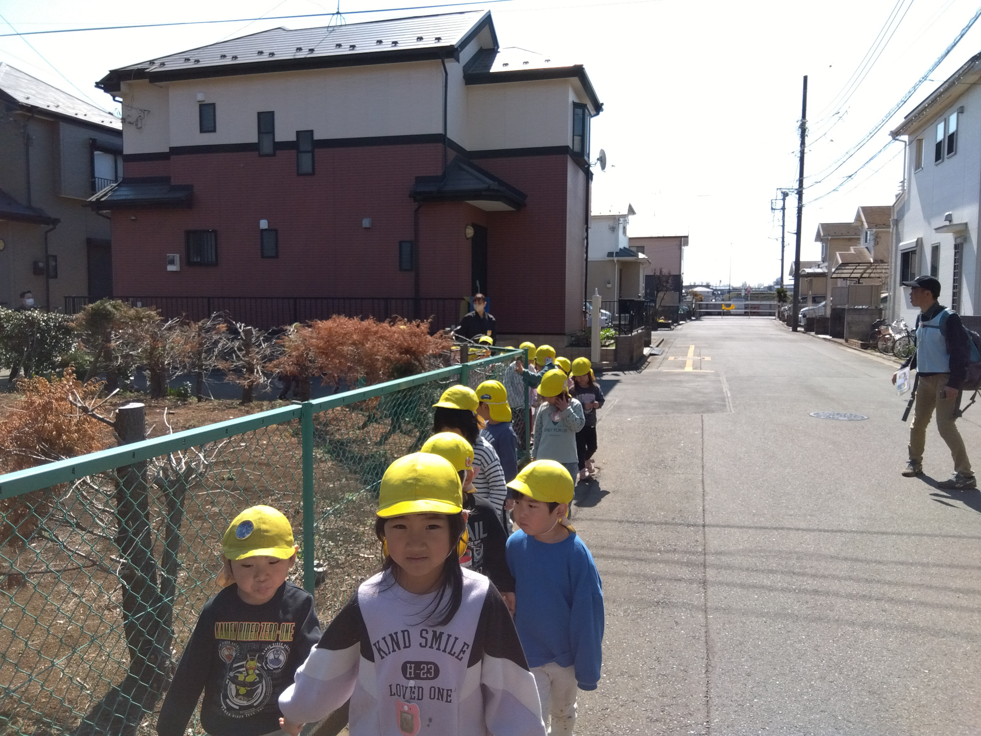道路の隅を並んで歩く子どもたちの様子