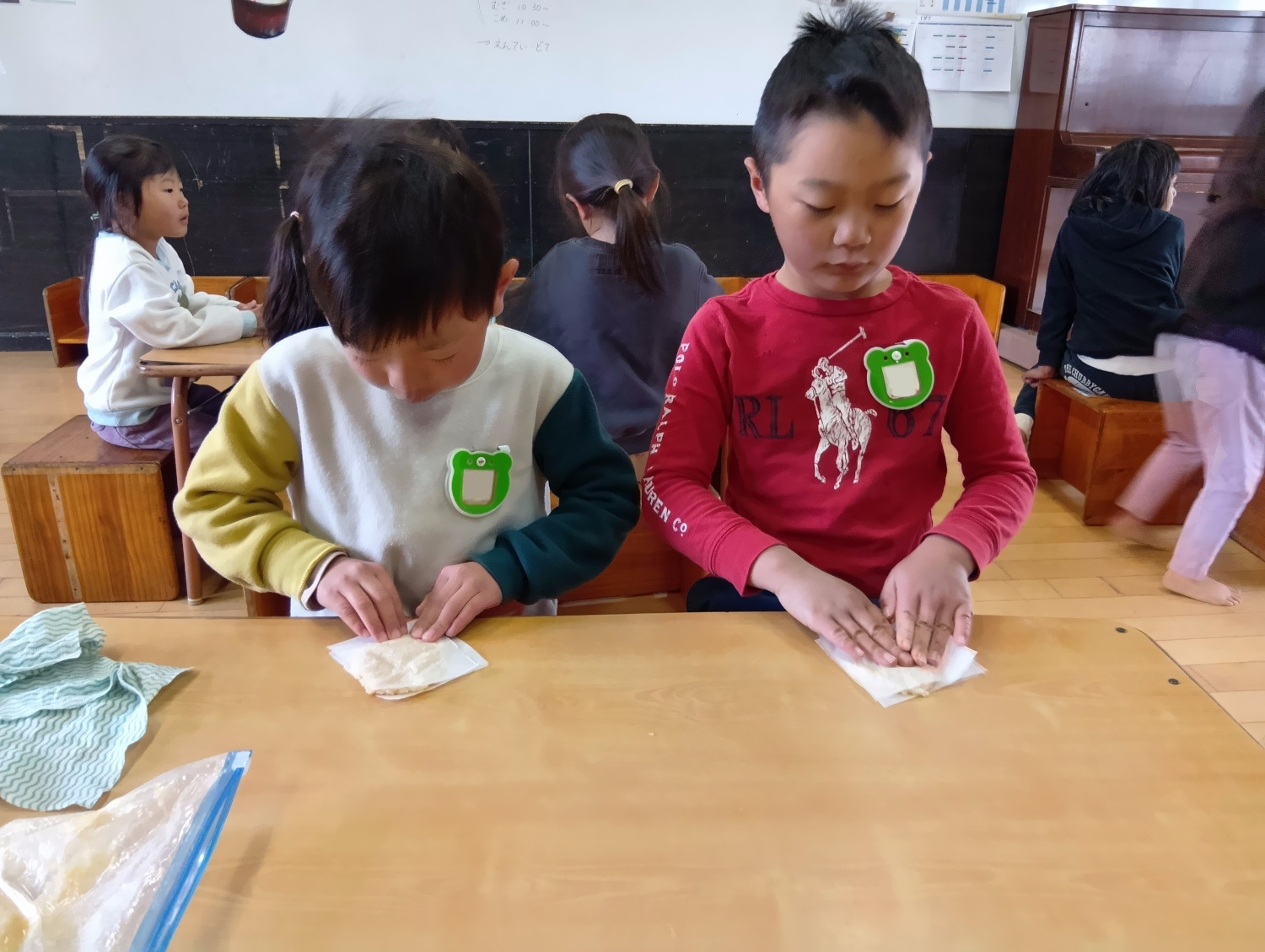 潰したお米を平らにのばす子どもたち