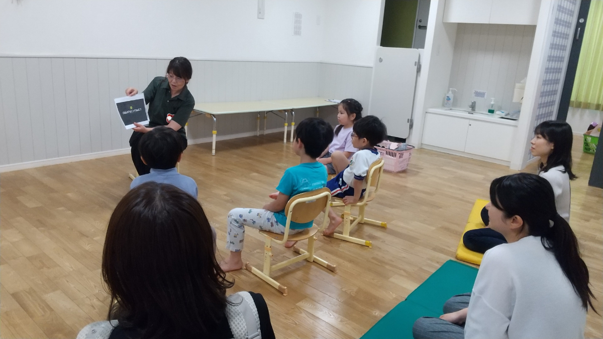 「おこめができるまで」の紙芝居を聞く親子の様子