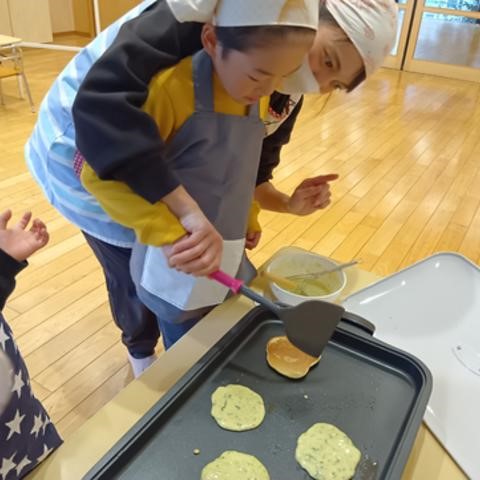 パンケーキをひっくり返す子ども