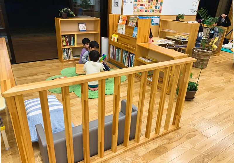 Children gathered and playing in a nursery classroom