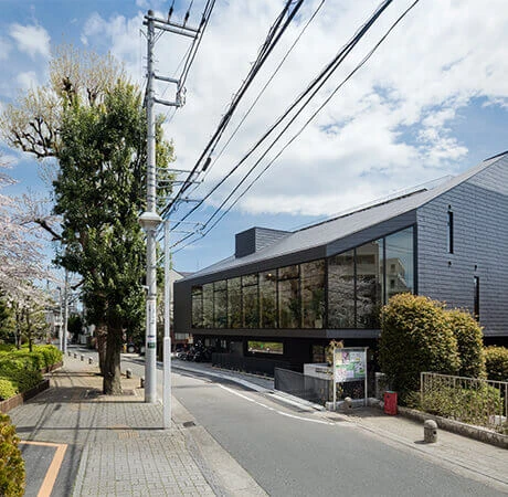 A black building along a sidewalk
