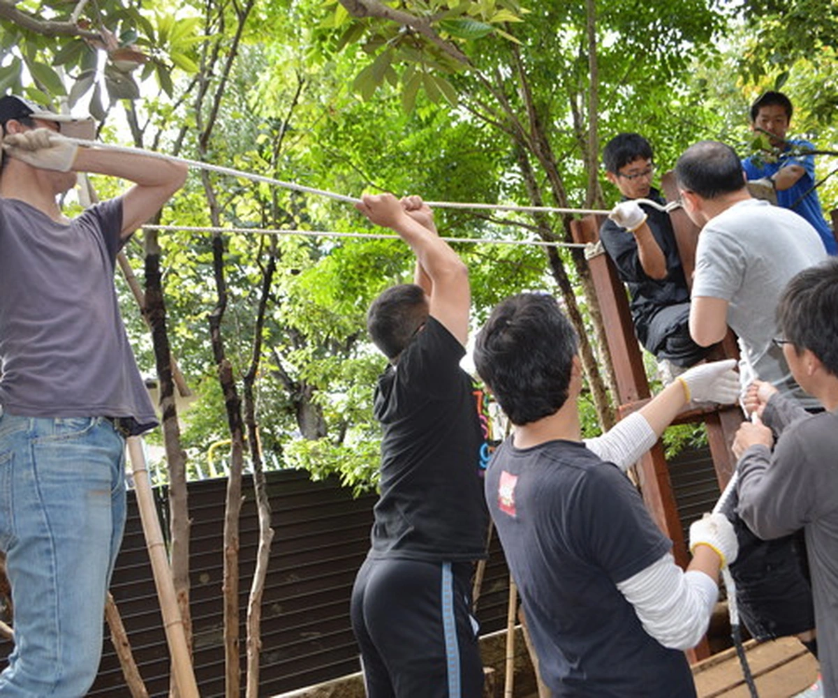 Parents working together to build a playground structure
