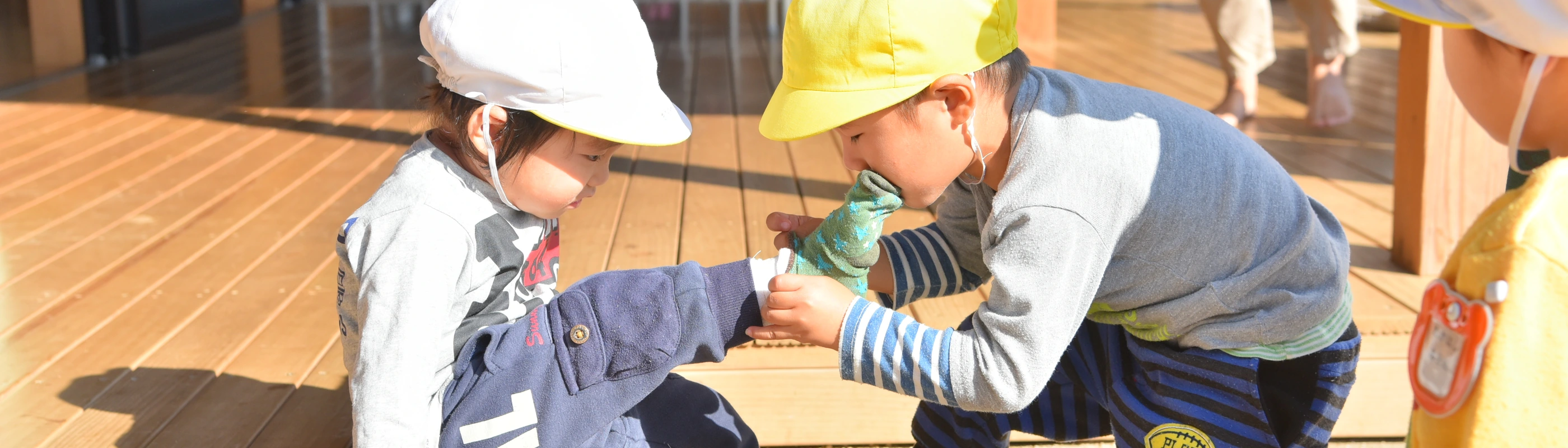 Children interacting on a wooden deck