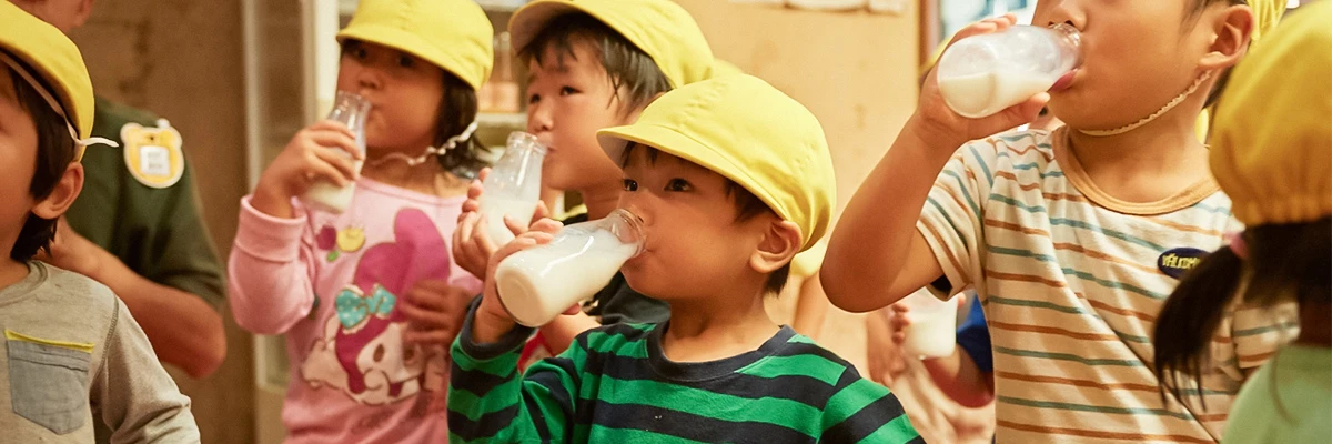 Children drinking milk after a public bath