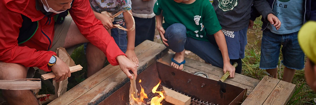 Children and staff gathered around a bonfire