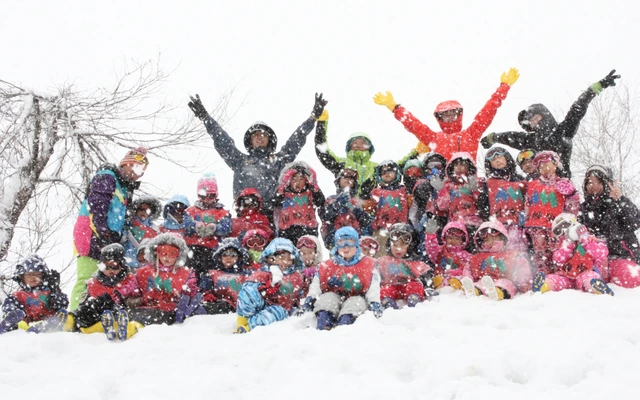 Children and staff posing at a snow camp