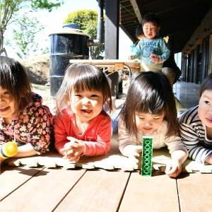 Children playing at a table on the veranda