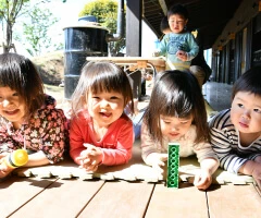 Children playing at a table on the veranda