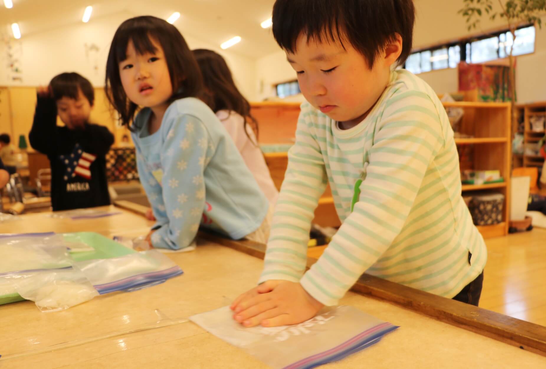 ご飯をつぶす子どもたち