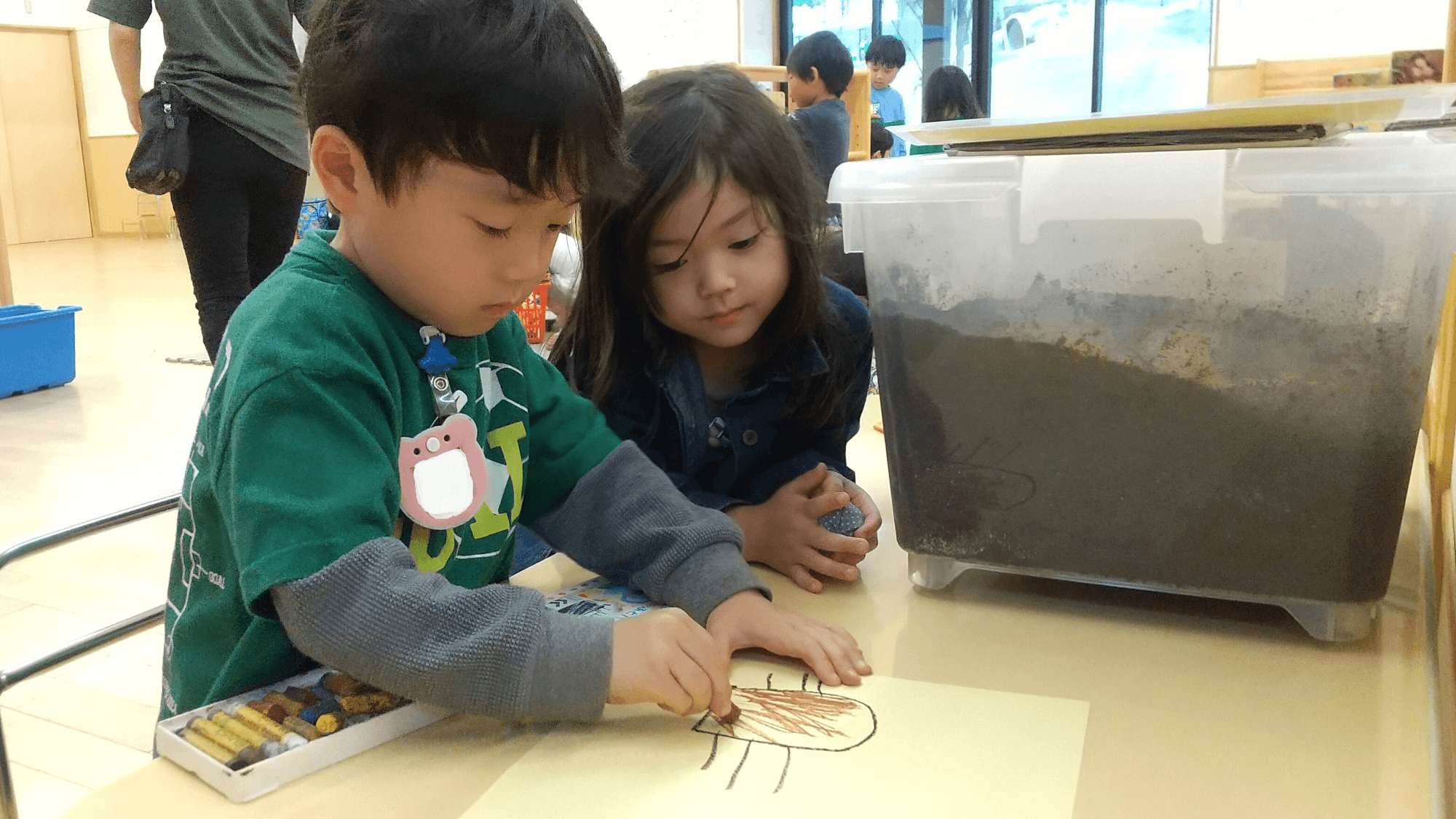 カブトムシの絵を描く子ども