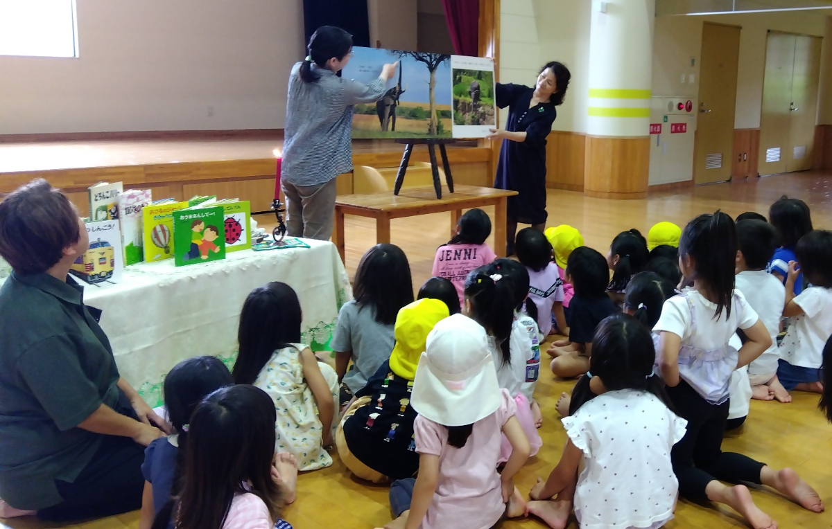 大型絵本の読み聞かせを熱心に聞く子どもたち