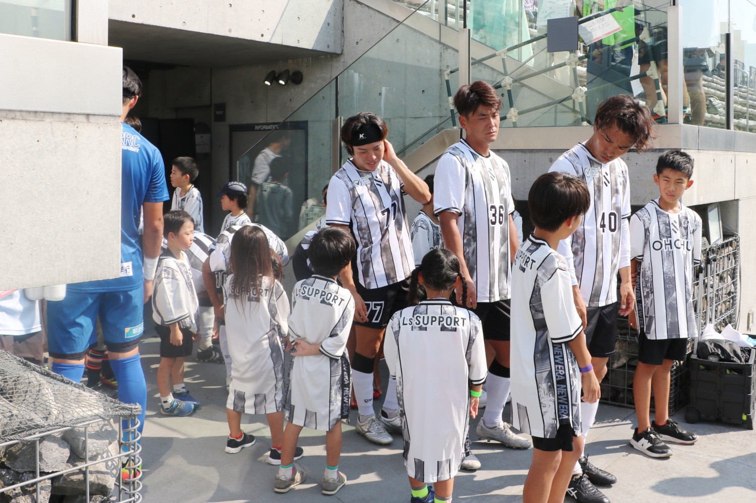 入場待機中に選手と話をする子どもたち