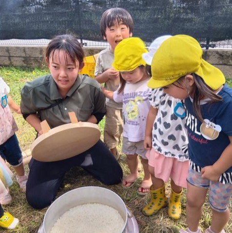 炊きあがったかまどのご飯を見る子どもたち