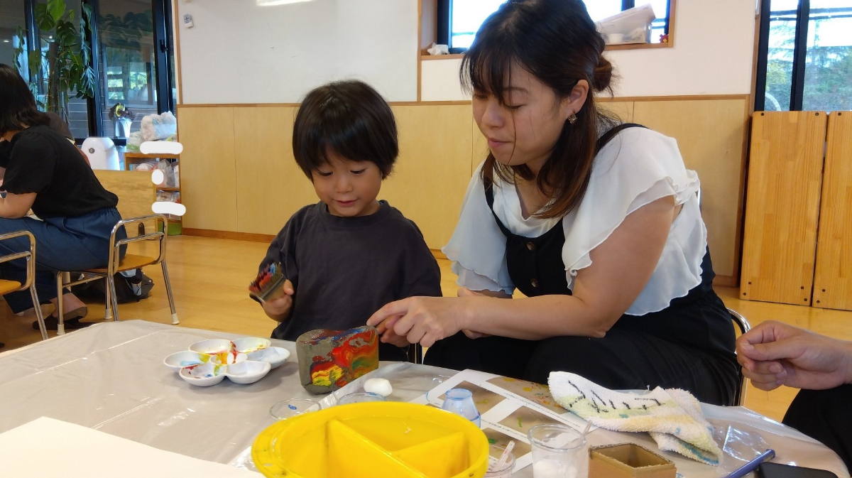 親子で石にペイントをする様子