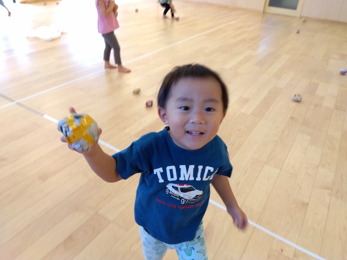 新聞紙を丸めたボールを握る子ども