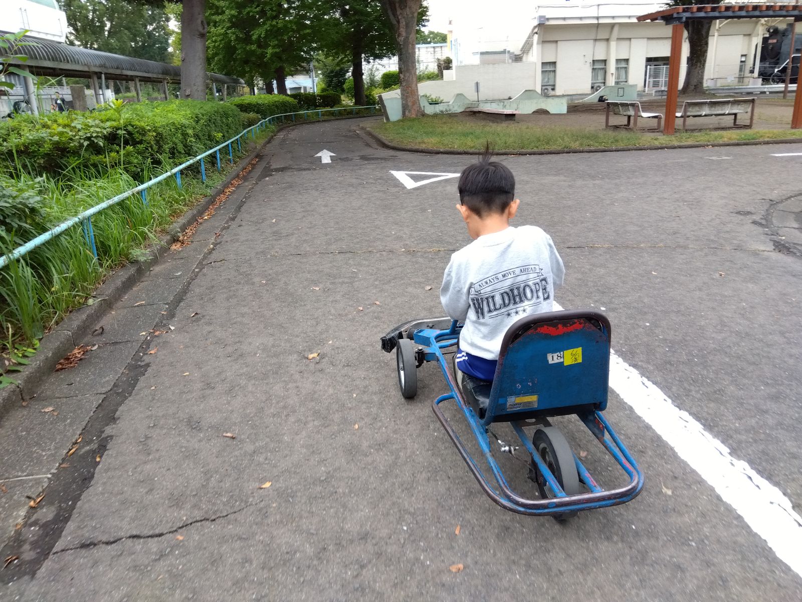 足漕ぎ車に乗る子ども