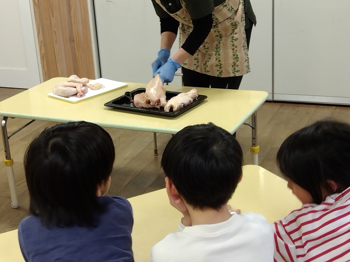 鶏肉を見る子どもたち