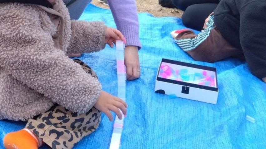 ストローを貼り合わせて遊ぶ子どもたち