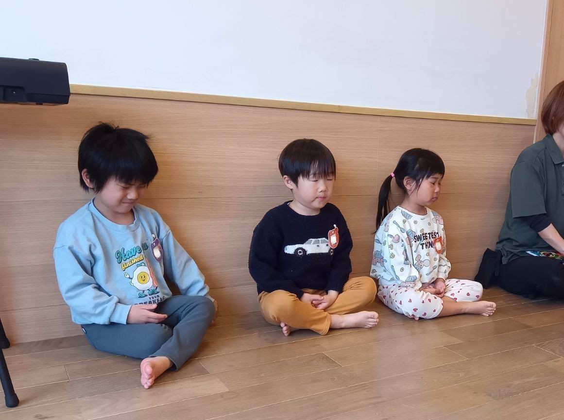 眼を閉じて胡坐を組んで座禅の時間を過ごしている