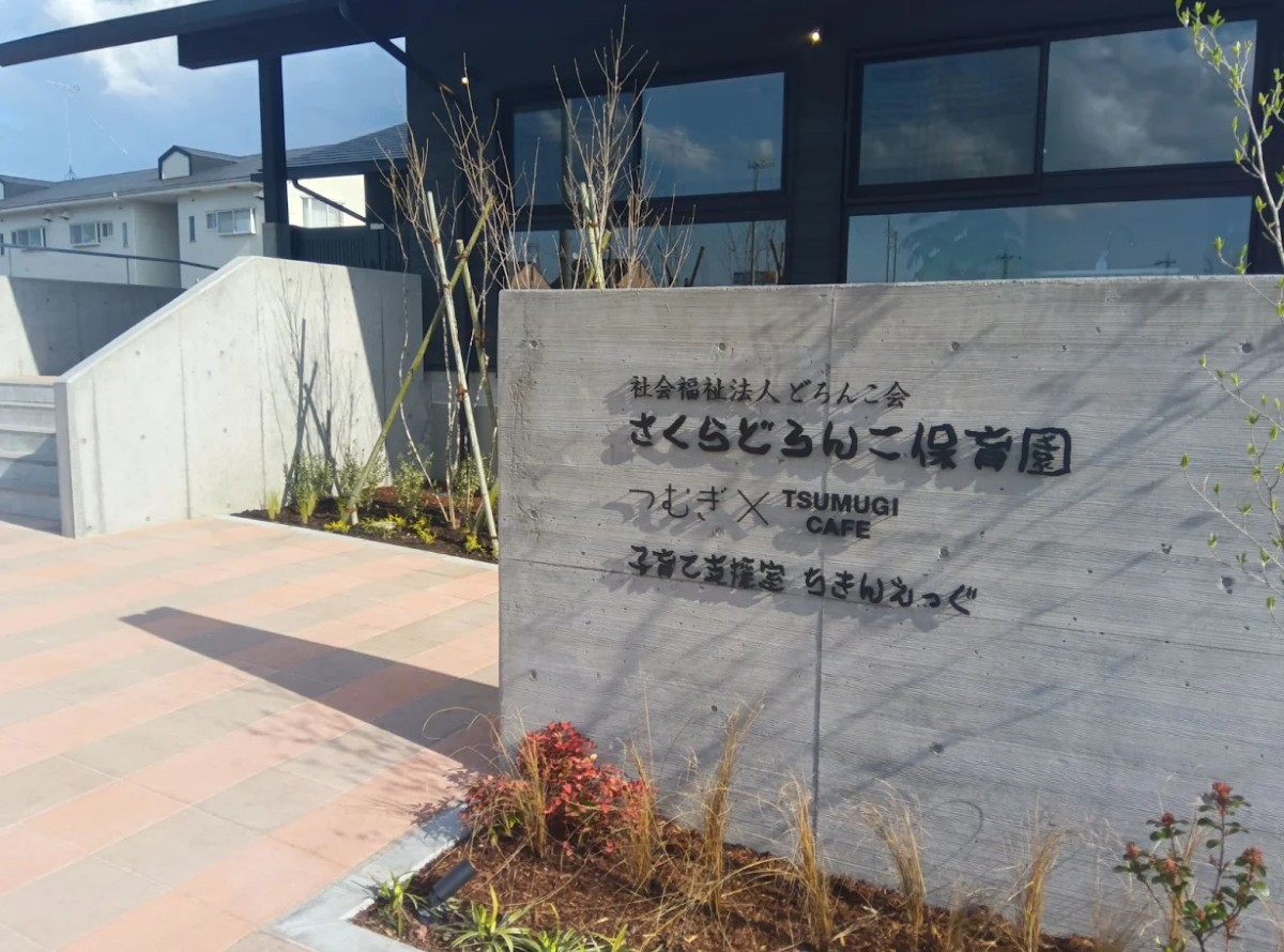 施設の入り口には施設名称が書かれており、植物が植えられている
