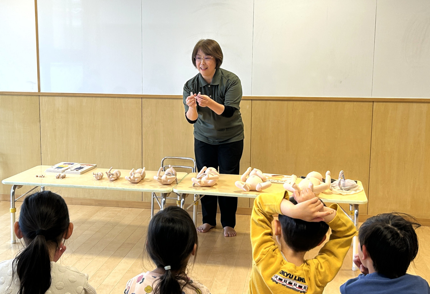 胎児人形を見せながら子どもたちに話をする様子