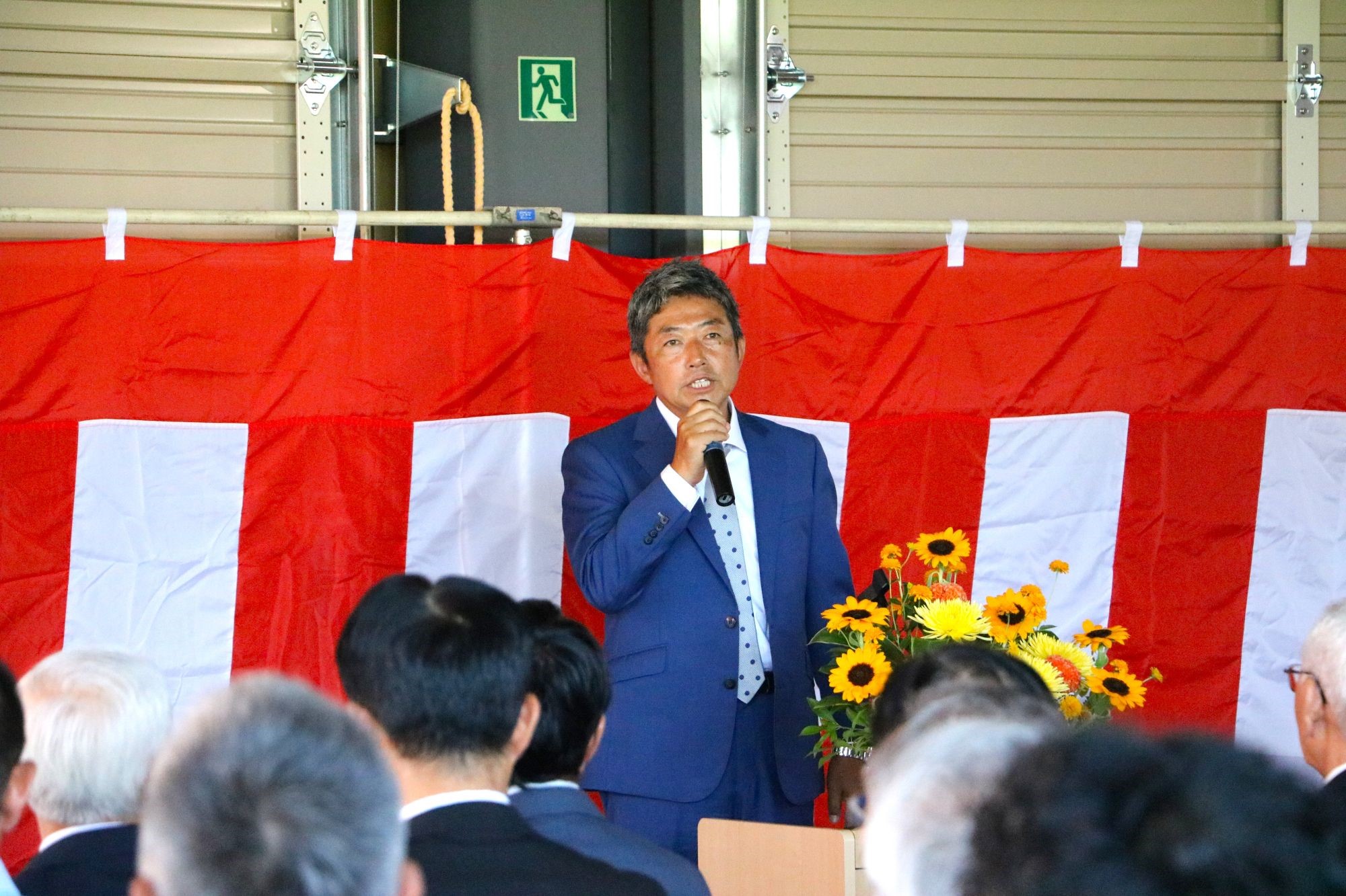 マイクで話す高堀代表